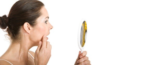 Woman inspecting her skin for cancer inspecting skin for cancer1 How to Identify a Squamous Cell Carcinoma
